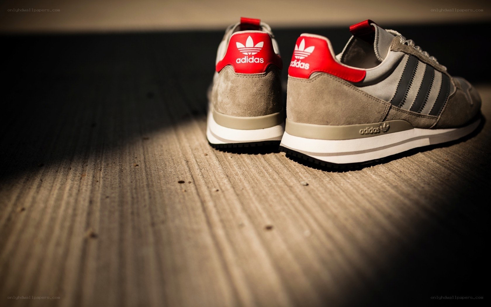 Adidas sneakers on wood floor