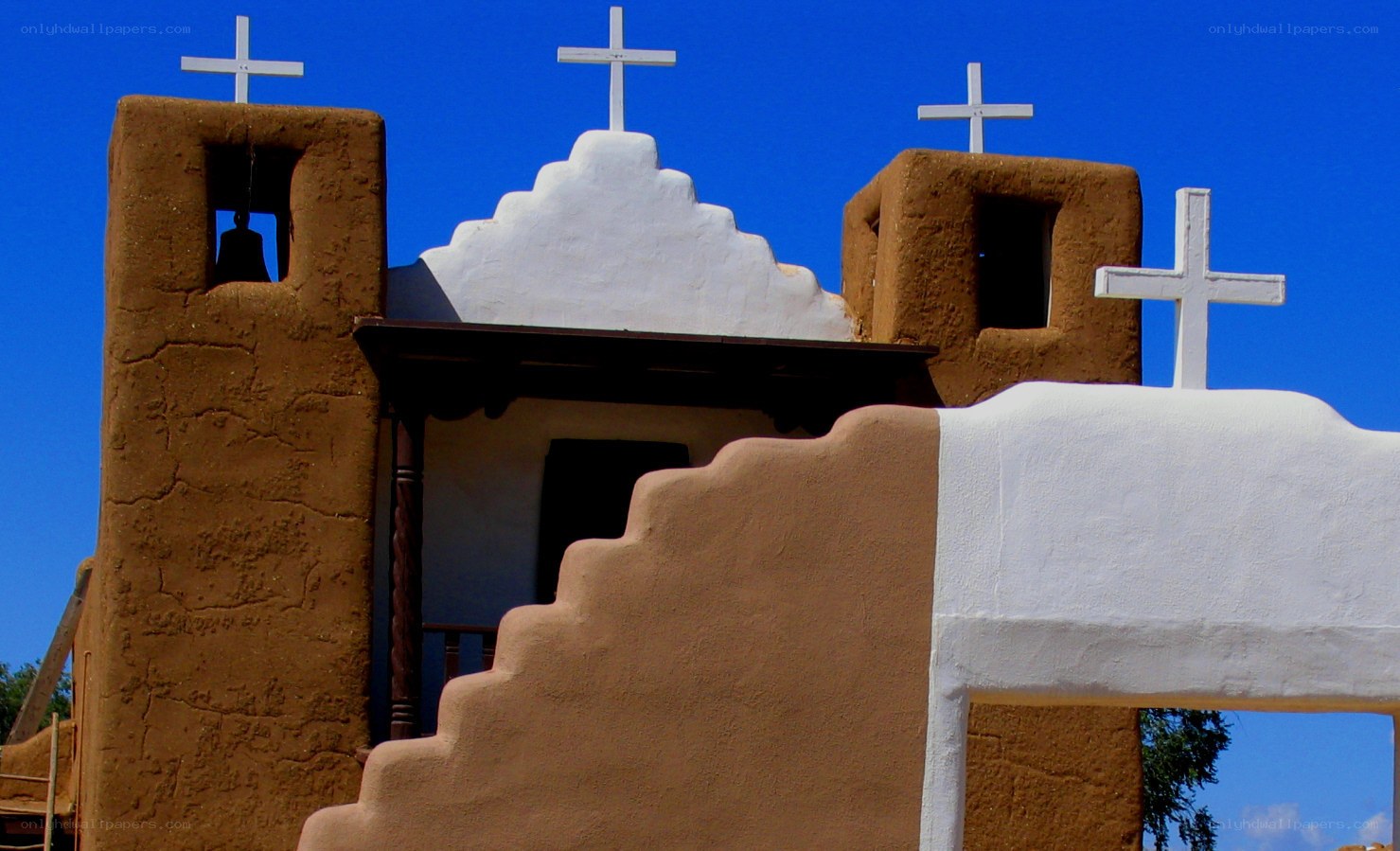 adobe church with white crosses