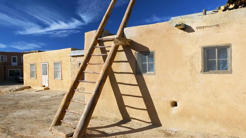 Adobe ladder against adobe building