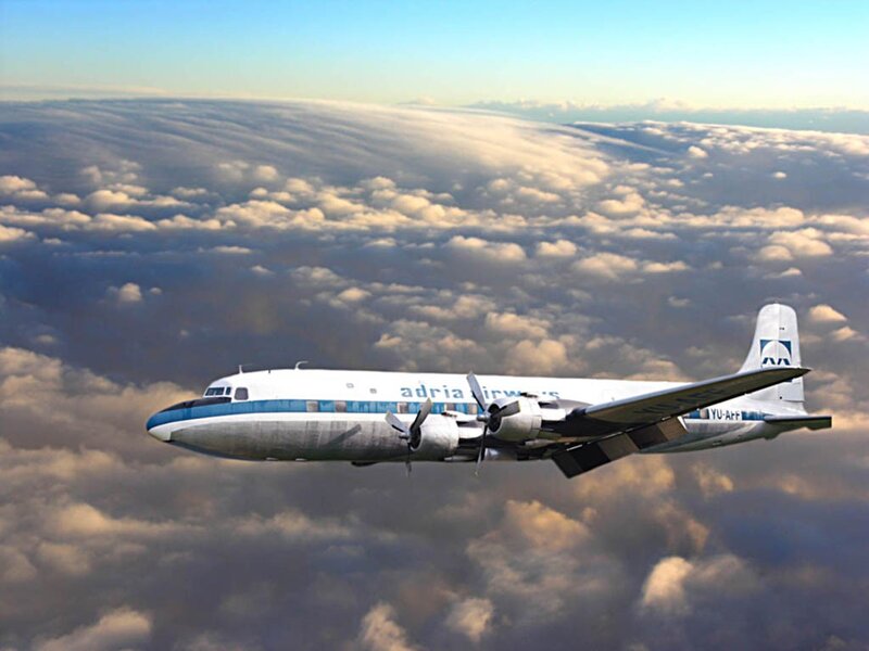 Adria Airways aircraft flying above clouds