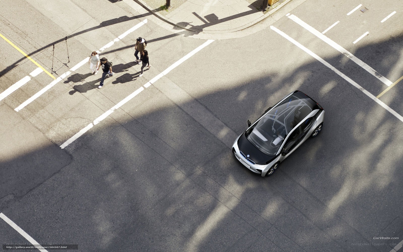 Aerial view of a car and pedestrians