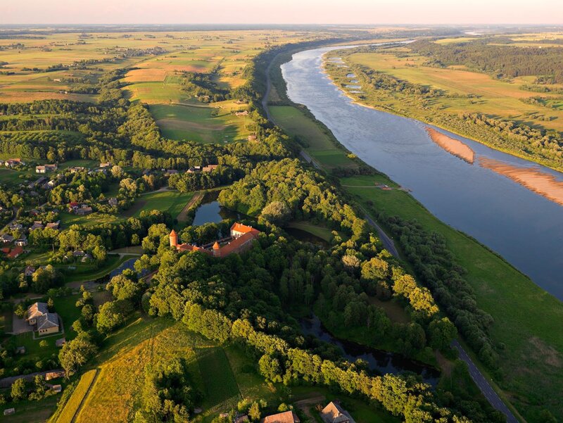 Aerial view of a castle by a river