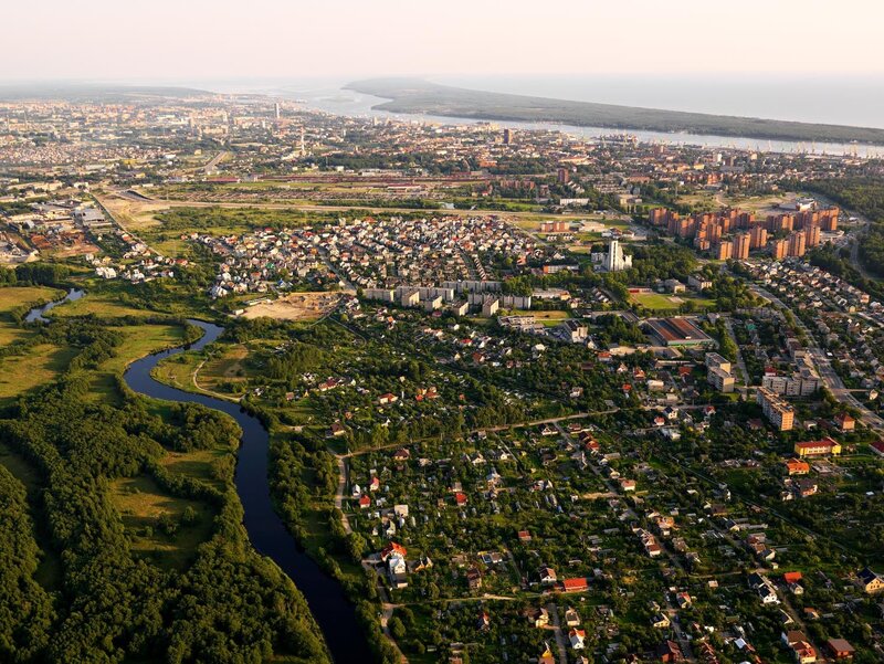 Aerial View of a City — Green, Serene, Afternoon, Photograph, River, Buildings