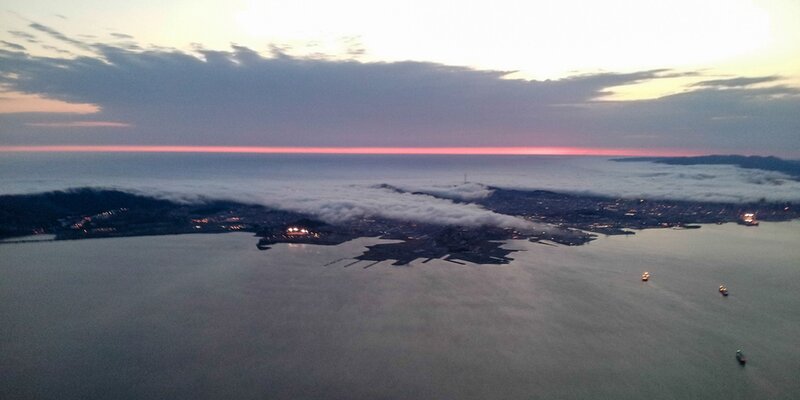 Aerial view of a coastal city at dusk