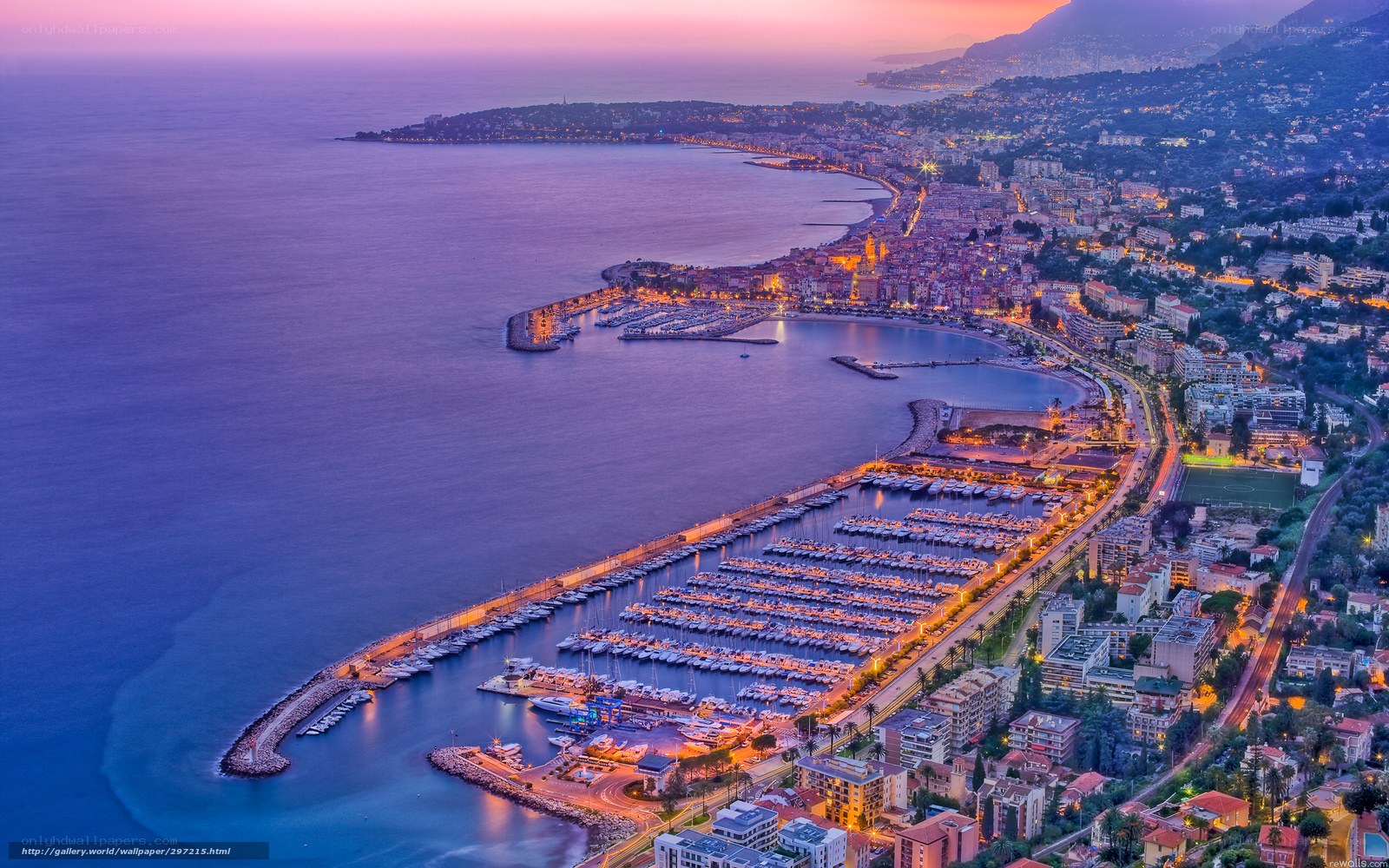 Aerial view of a coastal city at dusk
