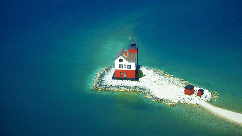 Aerial view of a lighthouse on a rocky island