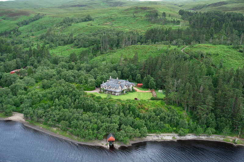Aerial view of a mansion by the lake