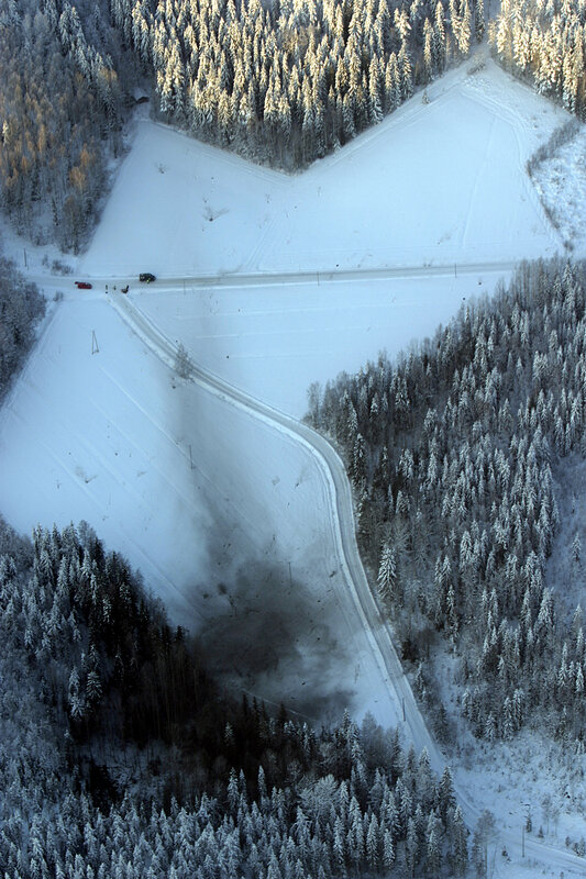Aerial view of a snowy forest road