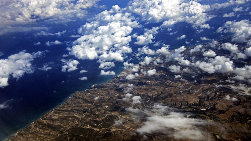 Aerial view of coastline and clouds