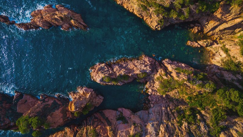 Aerial View of Rocky Coastline — Blue, Serene, Sunset