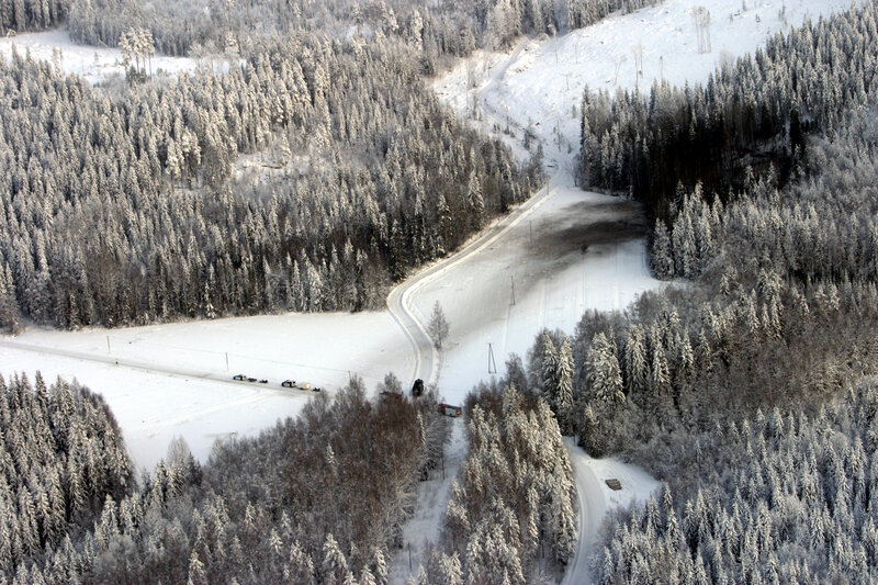 Aerial view of snowy forest road