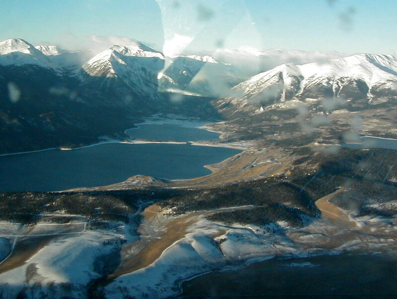 aerial view of snowy mountains and lake