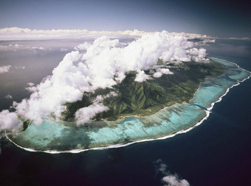 Aerial View of Tropical Island — Blue, Serene, Afternoon, Photograph, Clouds, Ocean, Coral Reef, Mountains