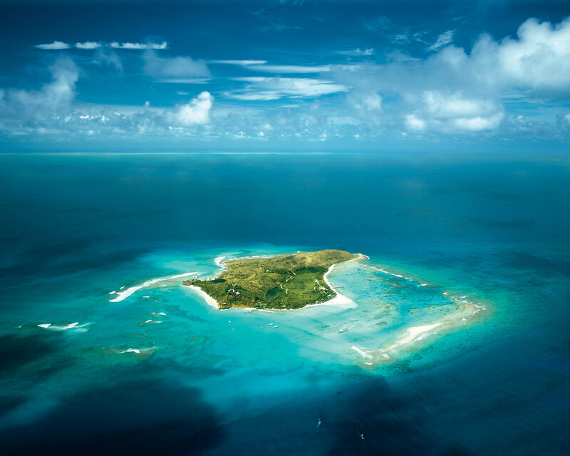 Aerial View of Tropical Island — Blue, Serene, Afternoon, Photograph, Ocean, Clouds, Coral Reef, Green