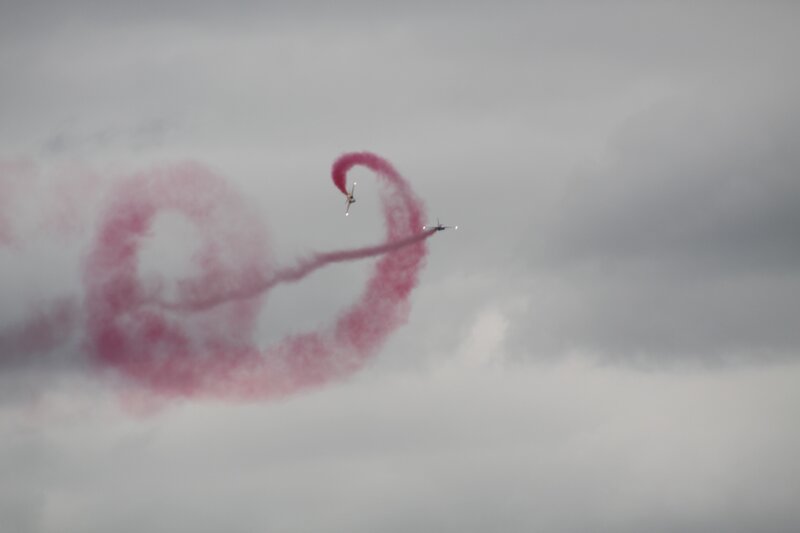 Aerobatic plane with red smoke