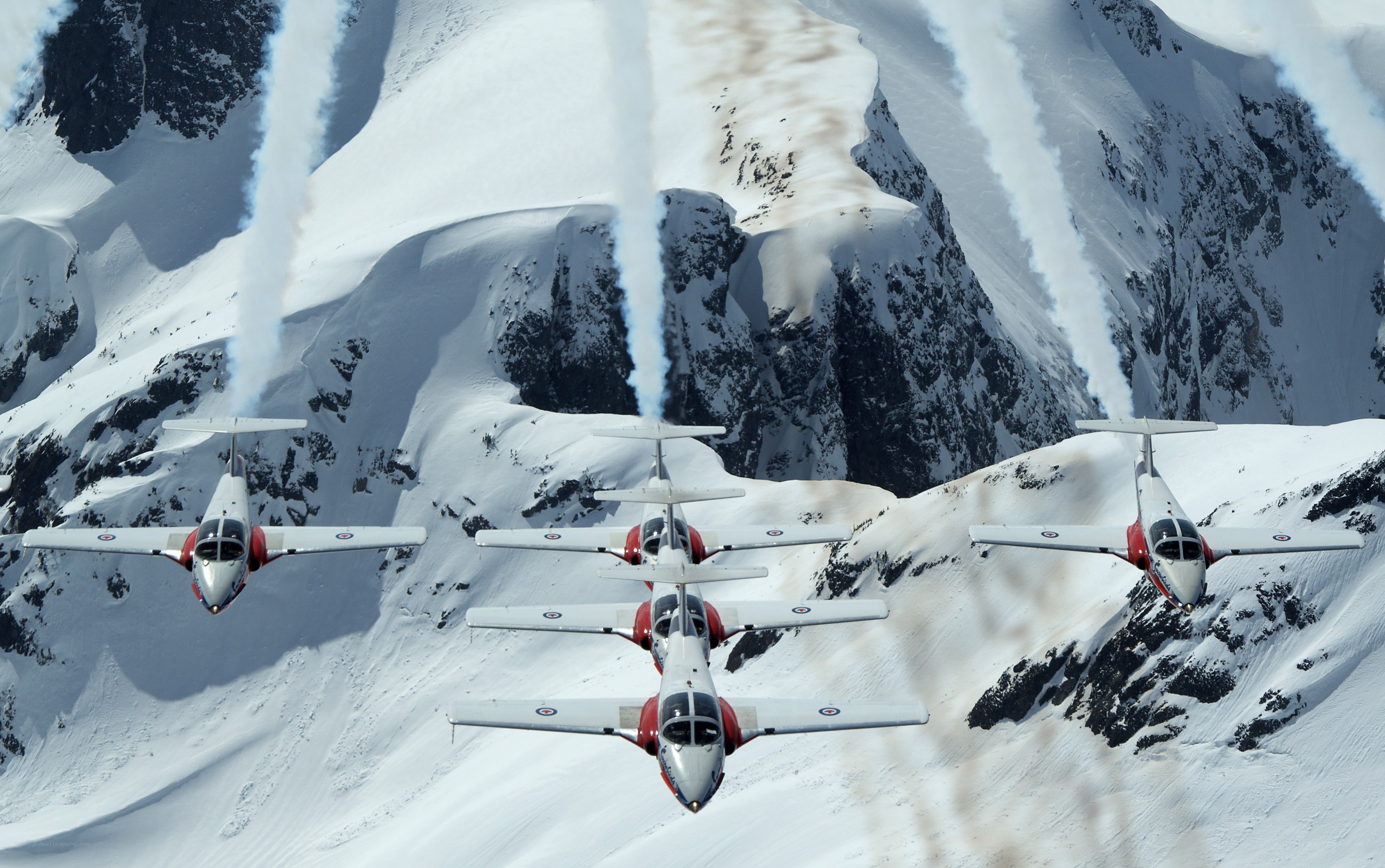 Aerobatic team over snowy mountains
