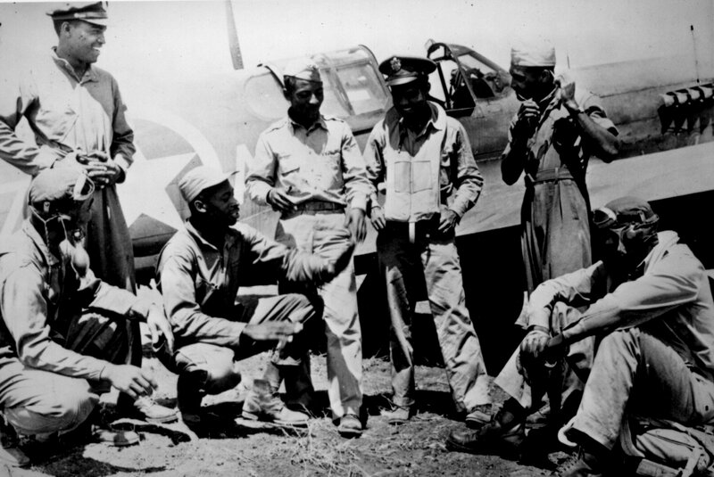 African American soldiers near a plane
