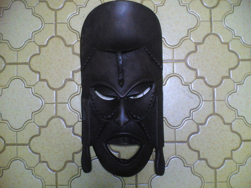 African mask on tiled wall