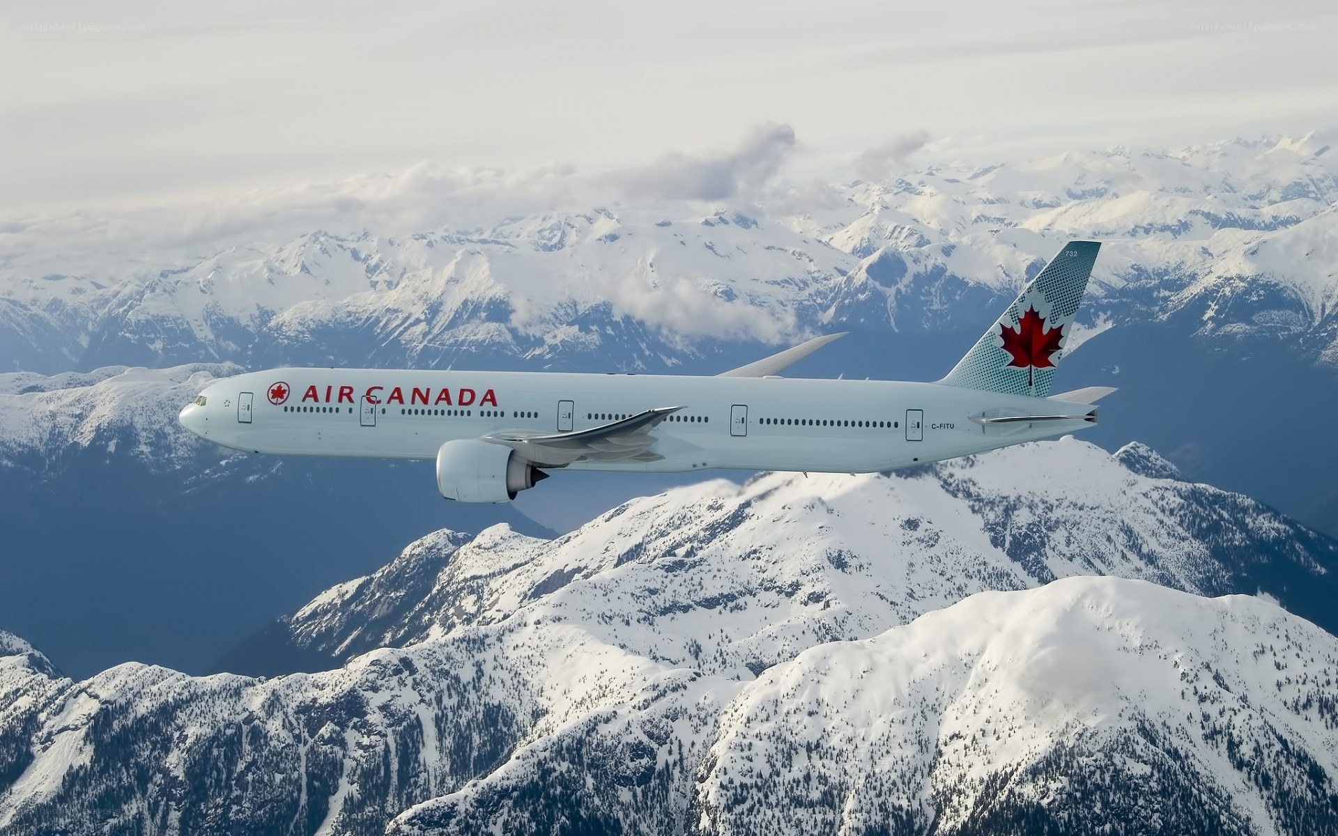 Air Canada plane over snowy mountains