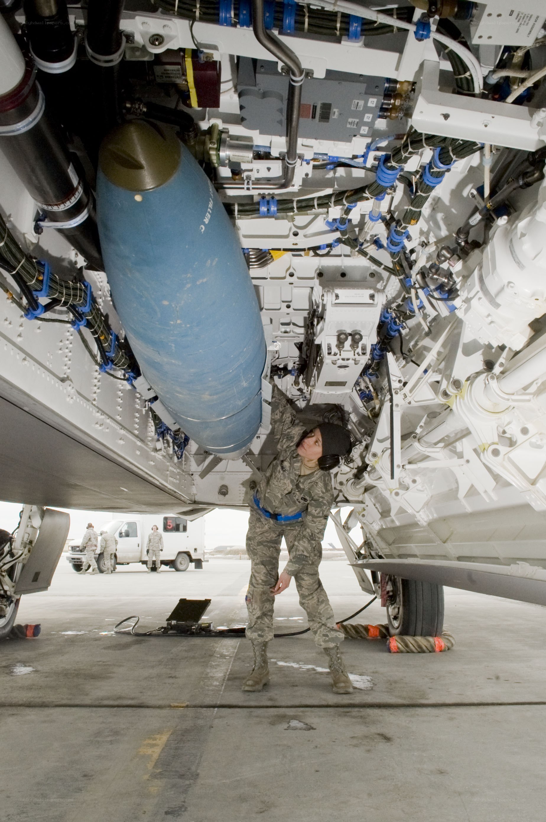 Air Force personnel loading weapon