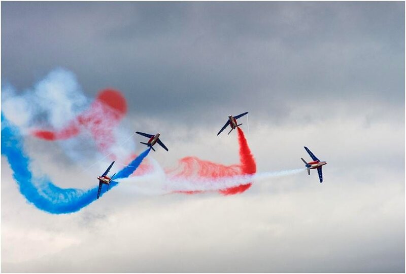 Air show with colored smoke trails