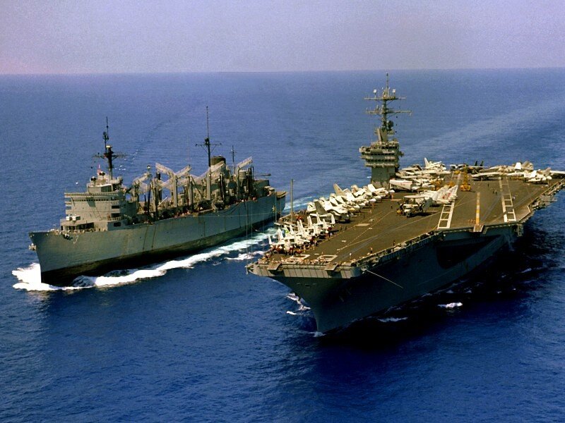Aircraft carrier and supply ship at sea
