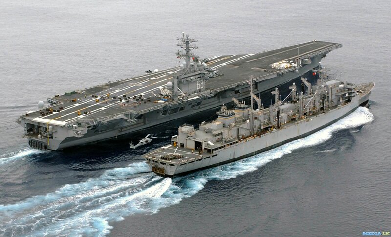 Aircraft carrier and supply ship at sea