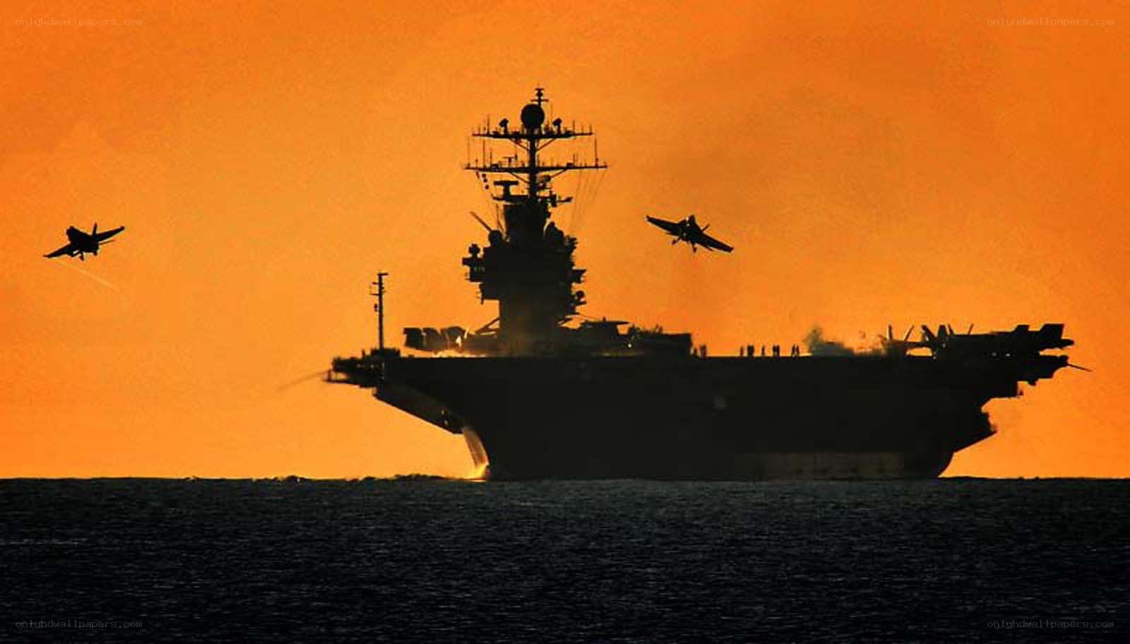 aircraft carrier at sunset