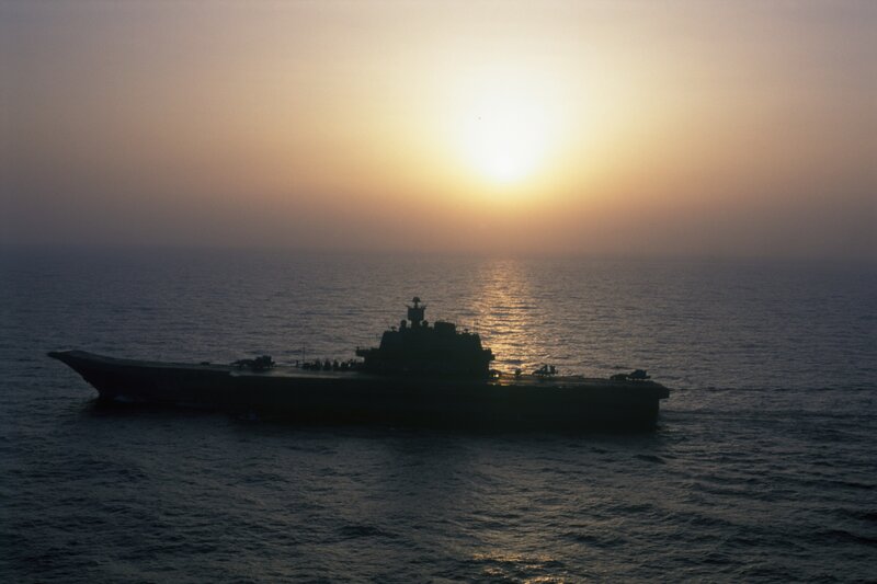 aircraft carrier at sunset