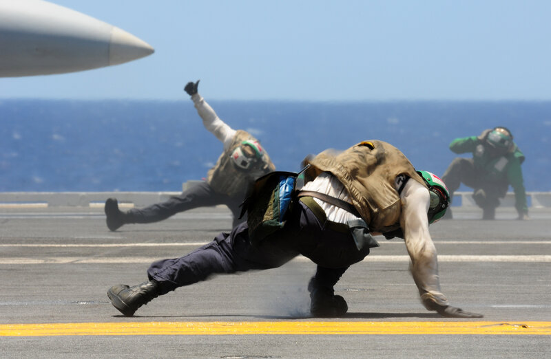 Aircraft carrier deck crew in action