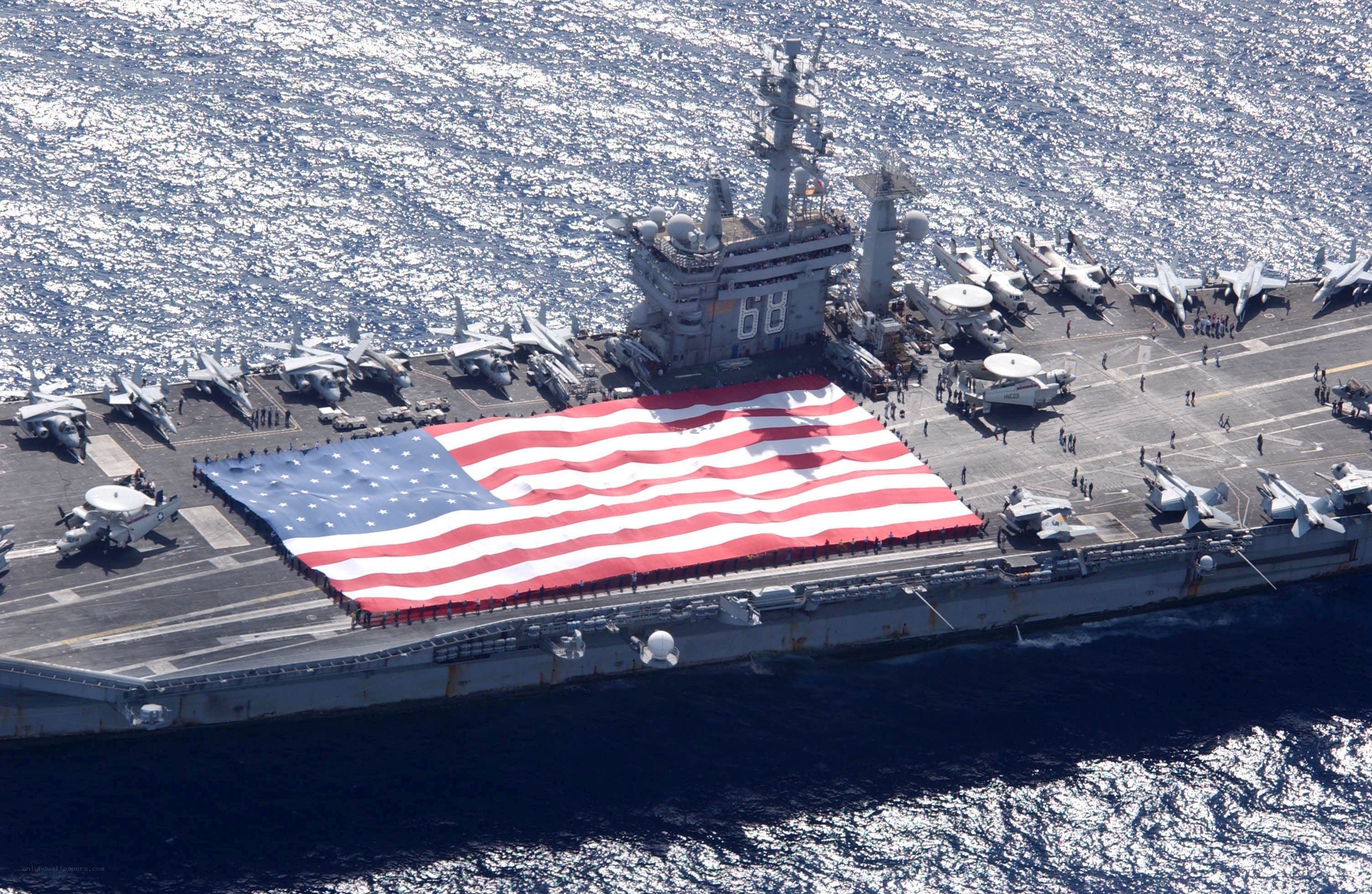 Aircraft carrier with large American flag