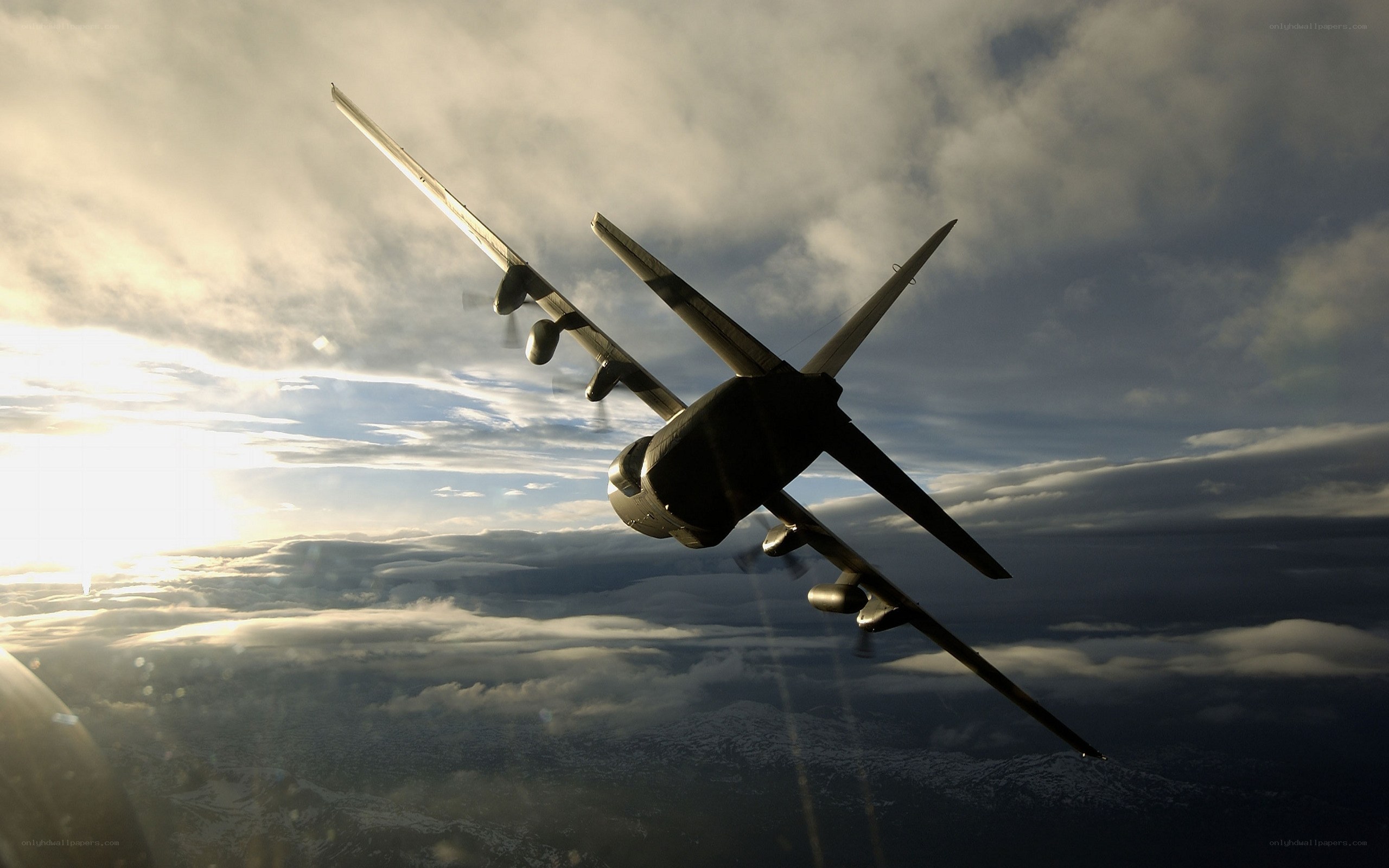 aircraft flying above clouds