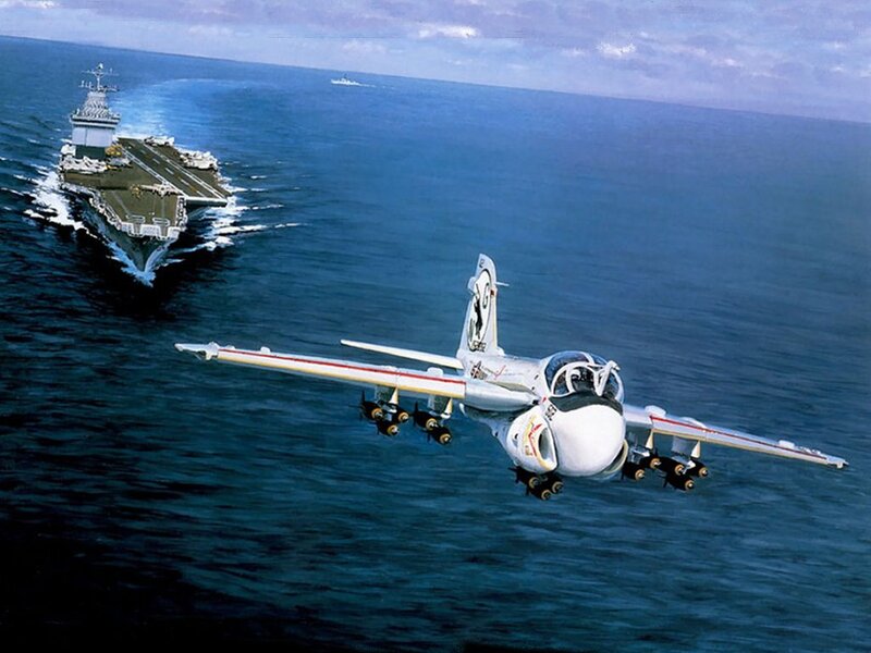 Aircraft flying over an aircraft carrier