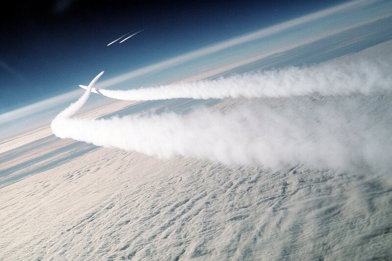 Aircraft Flying over Clouds — White