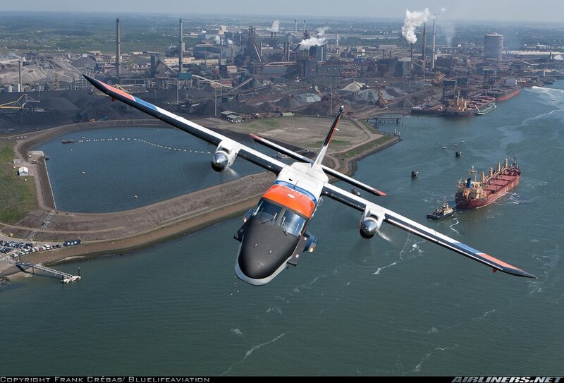 aircraft flying over industrial port