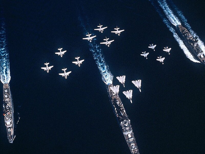 Aircraft flying over naval ships
