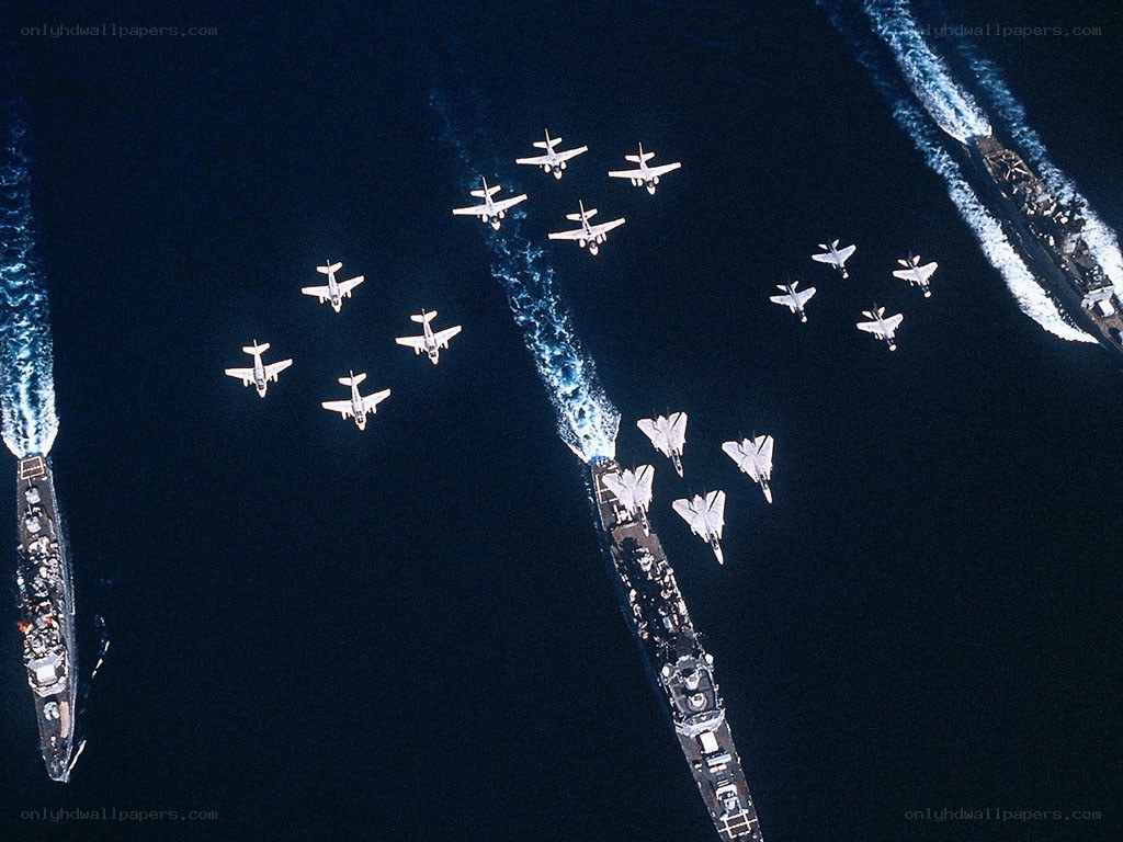 Aircraft flying over naval ships