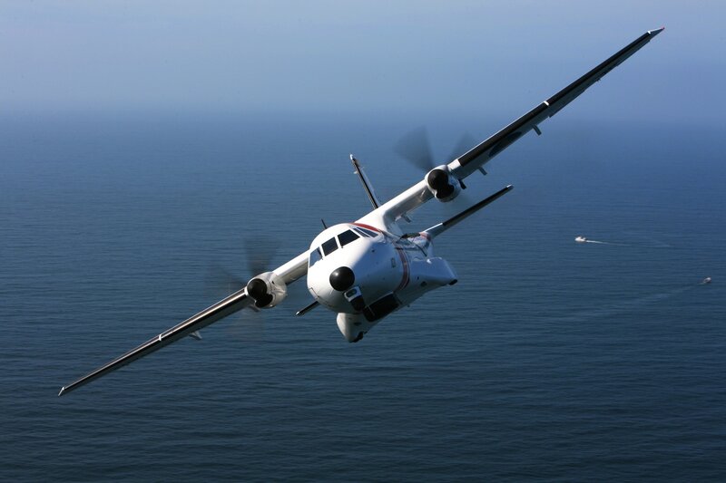 Aircraft Flying over Ocean — Blue