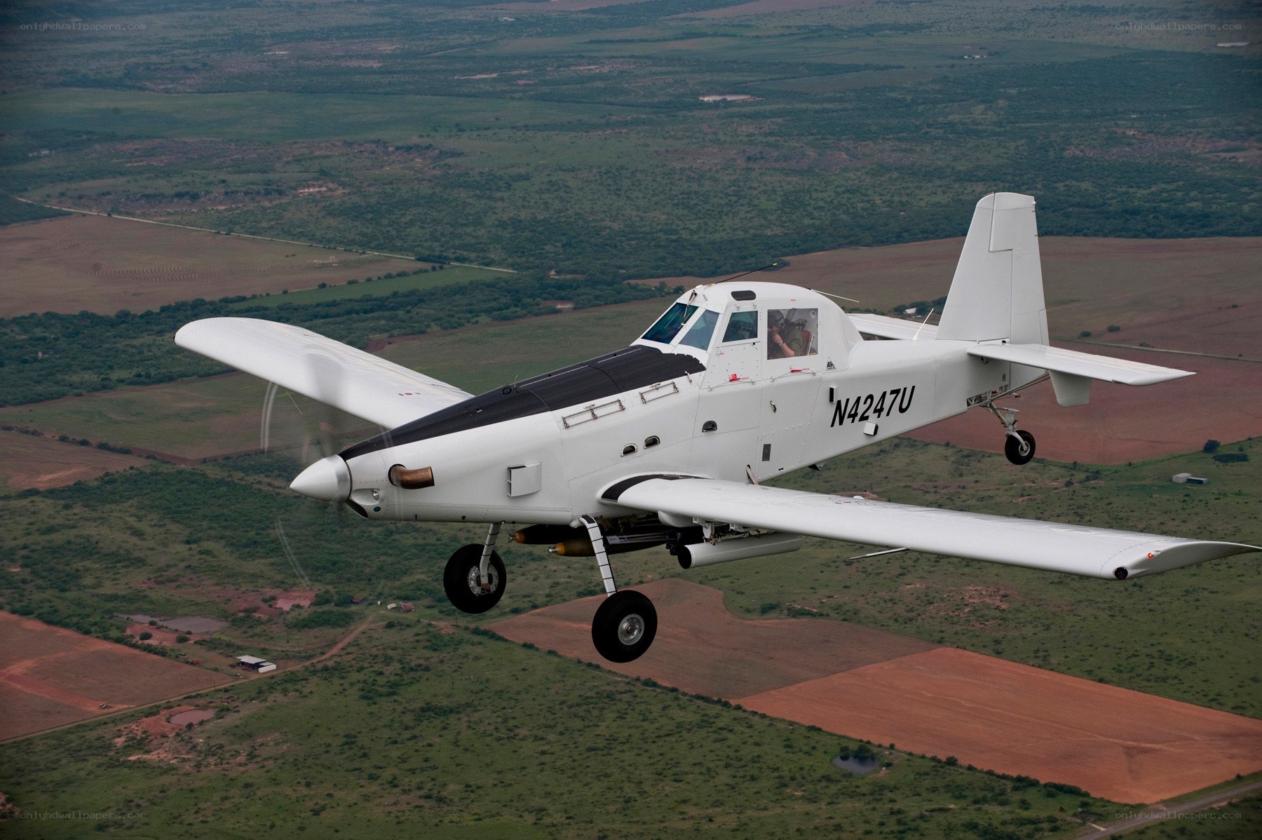 aircraft flying over rural landscape