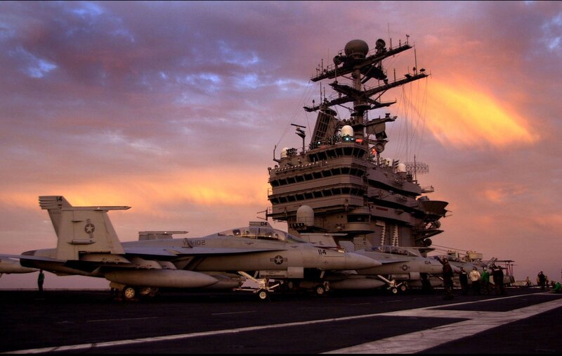 Aircraft on an aircraft carrier at sunset