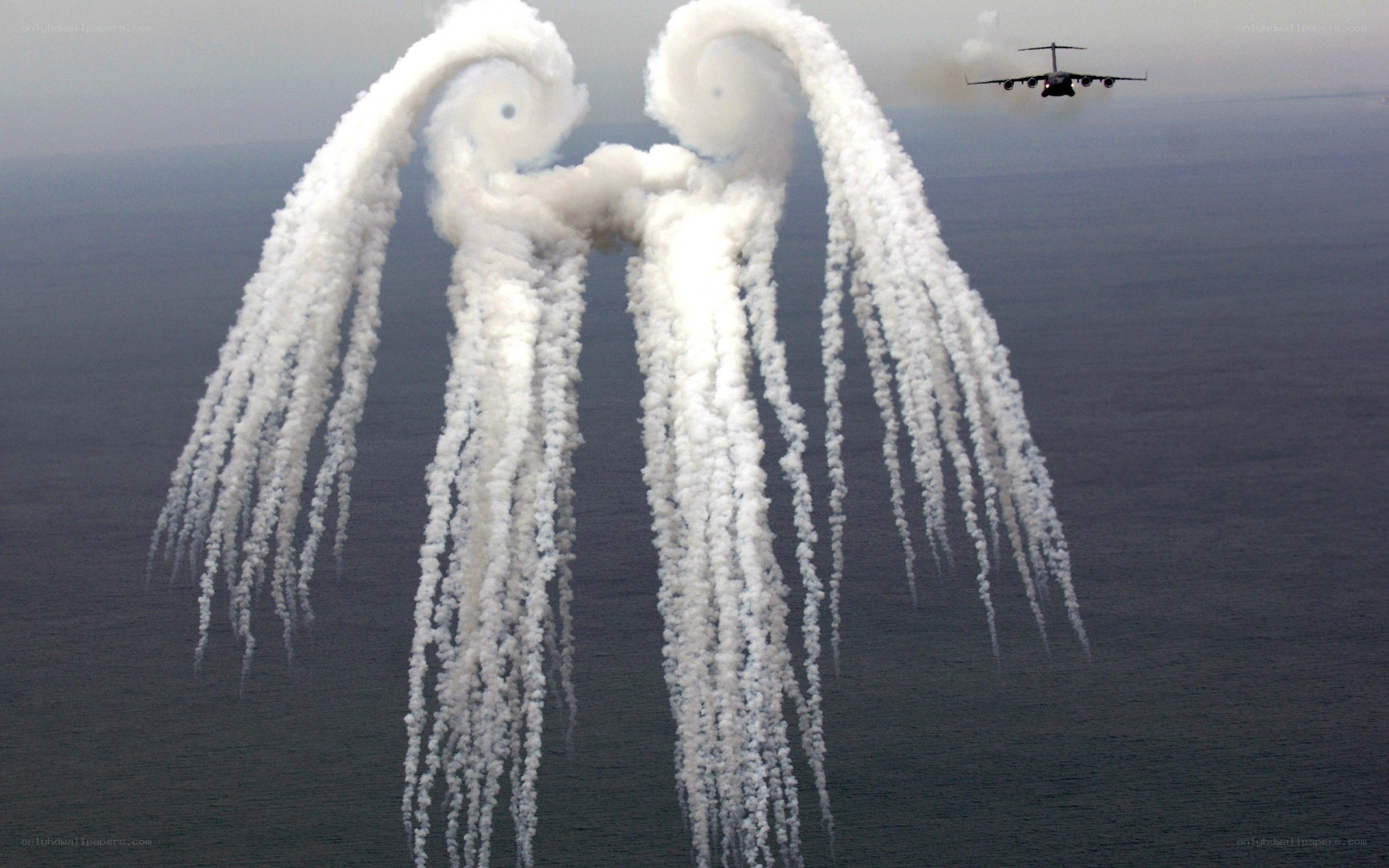 aircraft releasing flares over ocean