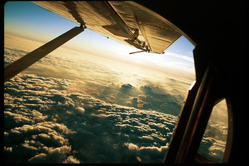 Aircraft wing above clouds