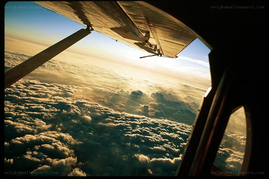 Aircraft wing above clouds