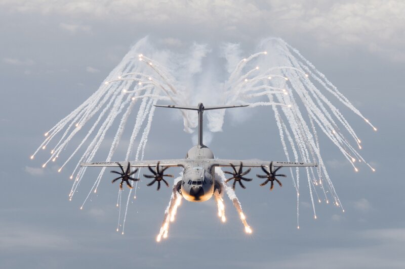 Aircraft with flares in sky