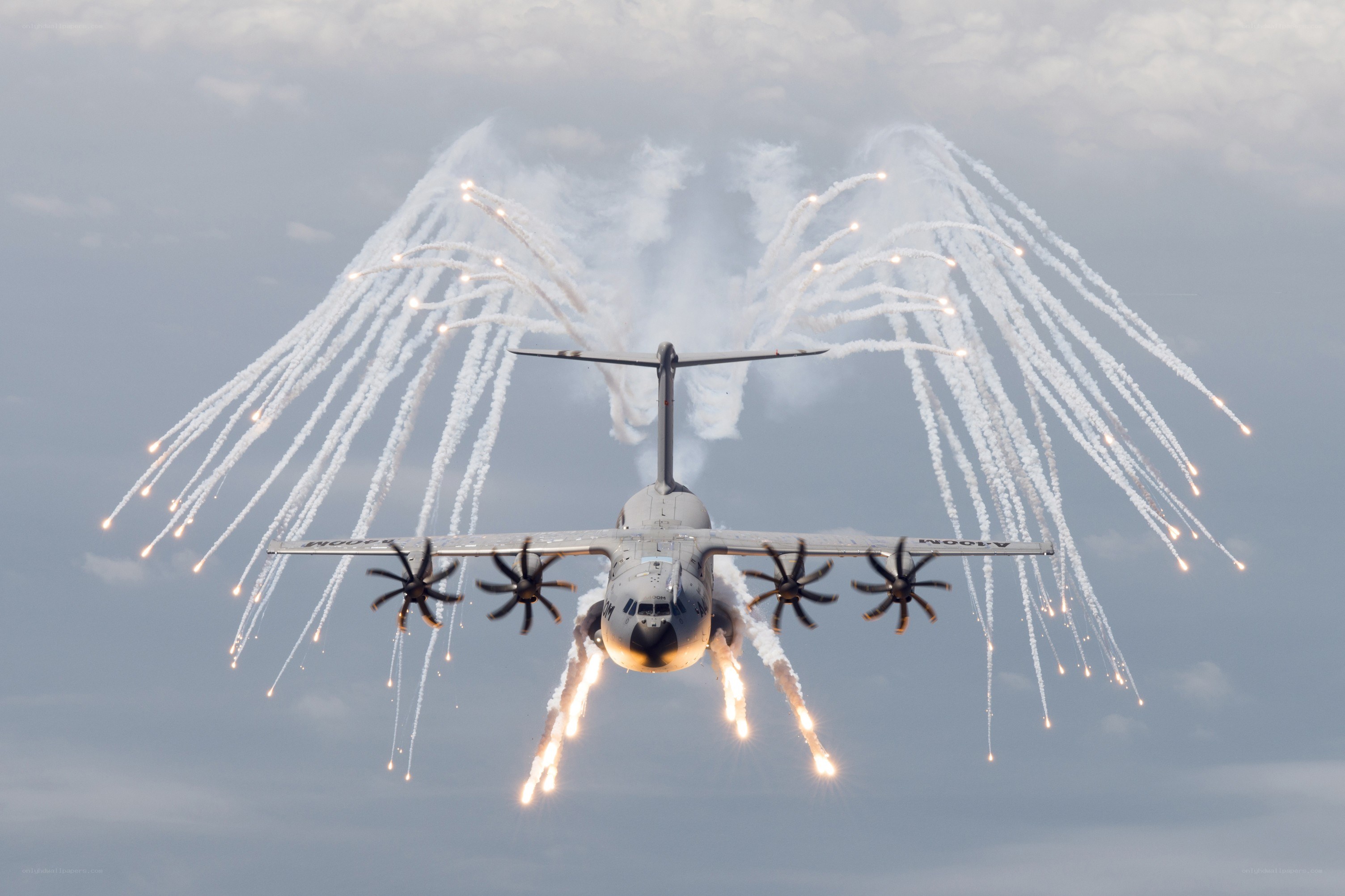Aircraft with flares in sky