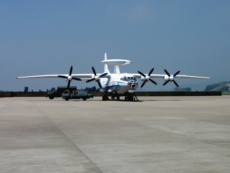 Aircraft with radar dome on tarmac