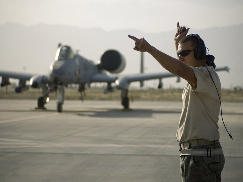 Airfield ground crew directing aircraft