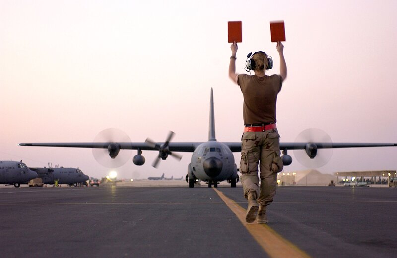 Airfield ground crew directing aircraft