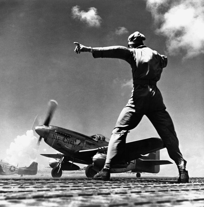 Airfield ground crew directing plane