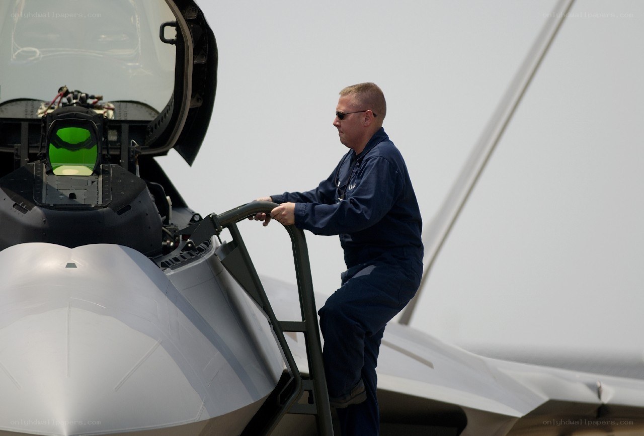 Airman boarding a fighter jet